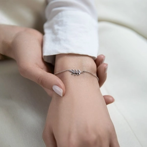Elegant 925 sterling silver leaf bracelet for women on model wrist in minimalist style