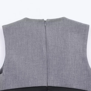 Close-up of grey woven short dress featuring a hidden back zipper and high-quality texture