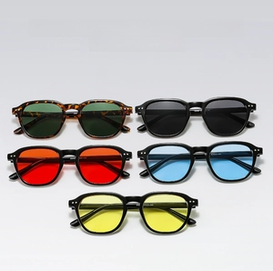 Detailed view of trendy small frame sunglasses in multiple candy colors and rivet accents
