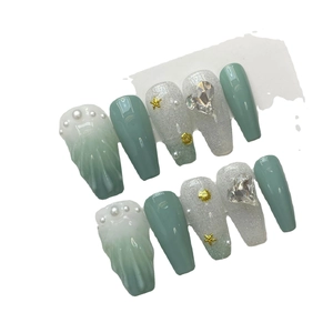 Handmade ocean shell press-on nails in mint green and sea salt with 3D starfish charms