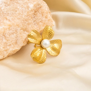 Detailed macro view of 18K gold plated flower ring with pearl and hammered petal texture