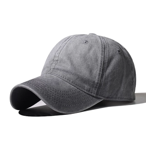 Close-up of the vintage washed cotton texture and stitching on the grey baseball cap