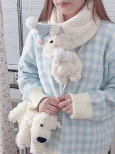 Close-up of fluffy white bear scarf and matching plush crossbody bag for winter warmth