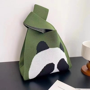 Green knitted panda handbag with knotted strap and trendy cartoon animal design