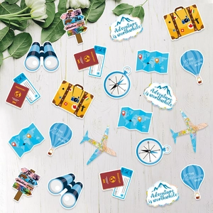 Travel theme party table confetti featuring passport map and airplane shapes on wood