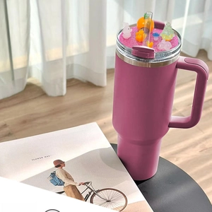 Close-up of pink 40oz tumbler lid with cute animal figurines and pink glitter base