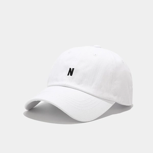 Close-up of white baseball cap with premium black N letter embroidery and six-panel detail