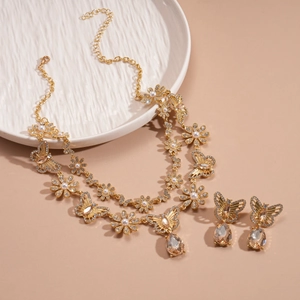 Close-up of vintage butterfly and flower necklace set with faux pearls and crystals