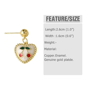 Detail view of gold plated cherry heart earrings made of copper and enamel