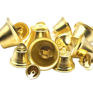 Golden Christmas bell charms for DIY crafts and festive decorations on white background