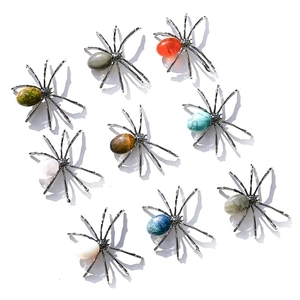 Detail of diverse spider ornaments made of natural crystals and colored minerals