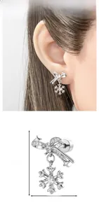 Detail view of snowflake bow earring showing 2.12cm height and 1.4cm width dimensions