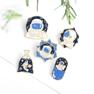 Set of 5 astronaut enamel pins in blue and white colors with gold metal edges