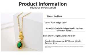 Detail view of pear-shaped green zircon pendant with gold stainless steel chain and butterfly detail