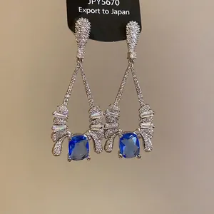 Elegant silver drop earrings featuring deep blue gemstones and shimmering zircon accents