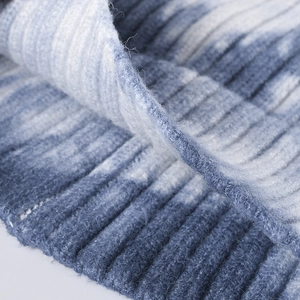 Winter tie-dye knit beanie featuring blue and white ribbed texture and warm yarn fabric