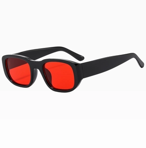 Detail view of retro rectangle sunglasses with glossy black frames and red lenses