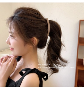 Macro detail of the matte khaki banana clip holding a high ponytail for women