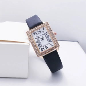 Detail of elegant rectangular watch with diamond-set bezel and black leather strap