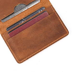 Close-up of brown crazy horse leather wallet showing internal card slots and stitching