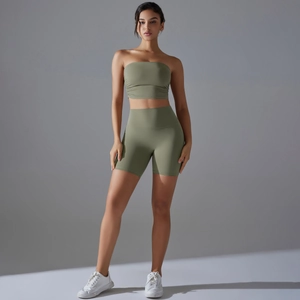 Detailed studio view of high-waist green yoga shorts and matching strapless sports bra