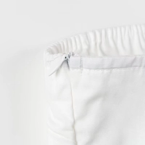 Detailed view of the invisible zipper and elastic waistband on the white summer crop top