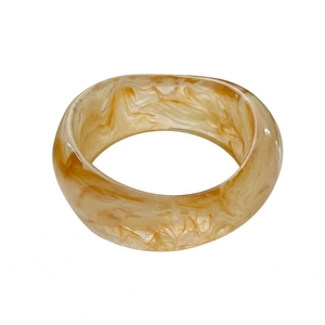 Wide irregular resin bangle with amber marble texture in minimalist retro style