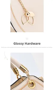 Close-up of polished gold-tone leaf charm and high-quality hardware on a leather handbag
