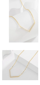 Detailed view of a gold V-shaped geometric pendant with sparkling pavé zircons