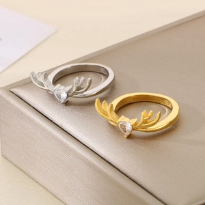 Detailed view of silver and gold reindeer antler rings with heart-shaped gemstones