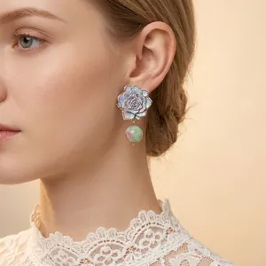French vintage rose flower earrings with blue petals and green marbled beads worn by model