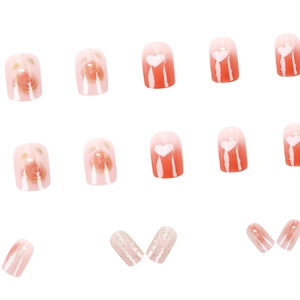 Short square press-on nails featuring pink gradient, heart patterns, and silver glitter finish