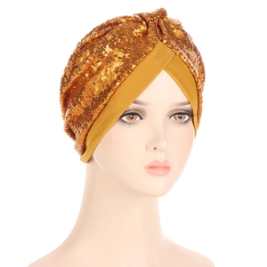 Detail of golden sequined turban hat featuring intricate stitching and classic knot design