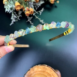 Detailed macro view of handmade crystal crown headband with colorful gemstones and gold wire
