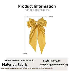 Detail showing golden satin bow hair clip dimensions 21x40cm with elegant long ribbons