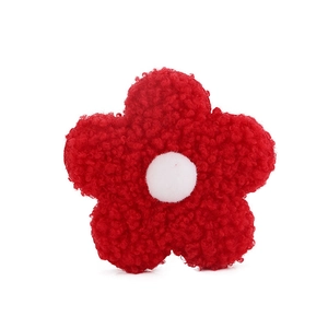 Close-up of a vibrant red teddy fleece flower accessory with five petals and white center
