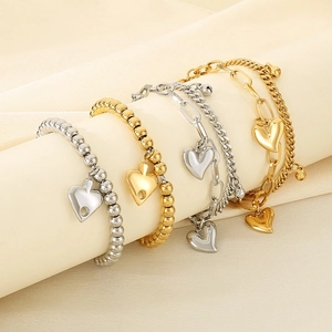 Detailed view of 18K gold plated steel bead bracelets with elegant heart pendants