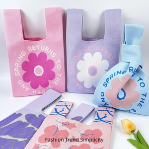 Floral knit tote bag with sunflower design and spring returns to the earth text