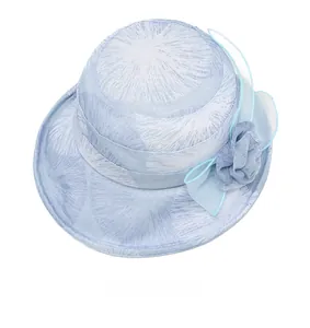 Top-down view of light blue sun hat with floral patterns and a 3D fabric flower detail