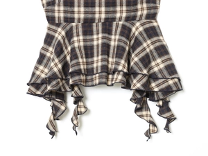 Detailed view of brown plaid camisole featuring layered ruffles and textured fabric