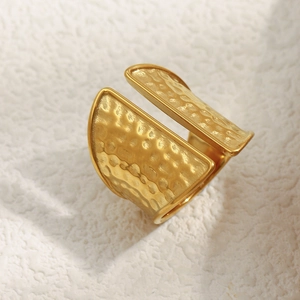 Macro detail of 18K gold plated hammered texture finish on wide open band ring