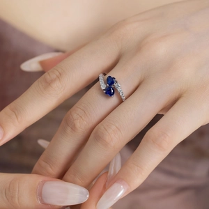 Close-up of double blue heart-shaped stones on S925 silver ring worn on hand