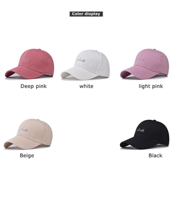 Close-up of five washed cotton baseball caps with shell embroidery in diverse colors