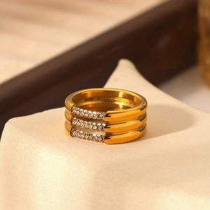 Dettaglio macro dell'anello multistrato in acciaio inossidabile dorato 18K e zirconi
