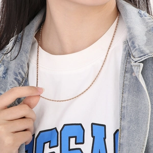 Rose gold twisted rope chain necklace shown on a model with casual white t-shirt outfit