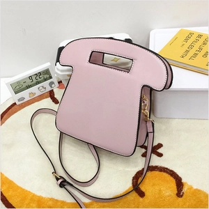 Detailed view of pink toast-shaped PU leather crossbody bag with black trim and gold hardware