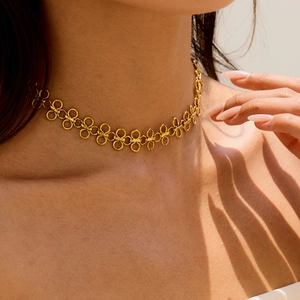 Minimalist gold titanium steel four-leaf clover necklace shown on a female model neck