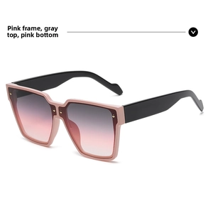 Detail of pink gradient sunglasses with oversized square frame and gold rivet accents