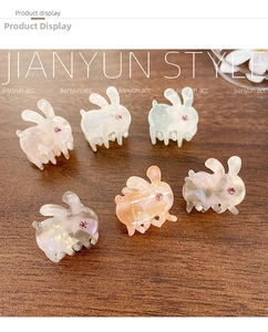 Close-up of mini rabbit acetate hair claws with pearlescent finish and pink rhinestones