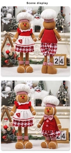 Detail of cute gingerbread man plush dolls with striped legs and chef hats for Christmas decor